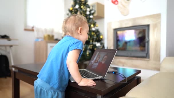 Little boy staying home in lockdown on Christmas holidays and video calling grandma and grandpa. Little grandson has video call with grandparents, kid kissing screen, funny video — Stock Video