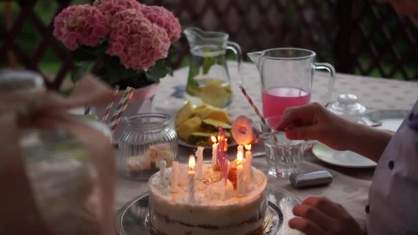 Close up of a birthday cake. A child lights a marshmallow on a candle fire. Have fun, funny video, childrens birthday party — Stock Video