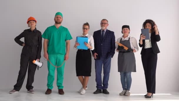 Group of happy business people with different occupations. People of different professions on a white background in the studio — Stock Video