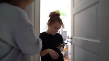 Conflict between mother and teenage daughter. The mother tries to talk to the girl. My daughter is distracted by her smartphone, Internet addiction. Teenager at her room