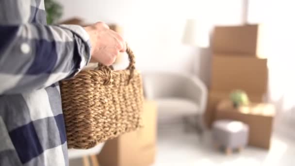 Buying a new home concept. A young woman is busy moving to a new apartment. Brings in boxes and sits down to rest, smiles happily — Stock Video