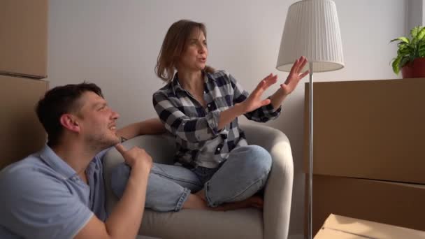 El marido y la esposa disfrutan de la compañía de los demás después de mudarse a un nuevo apartamento. Pareja feliz soñando con el futuro — Vídeos de Stock