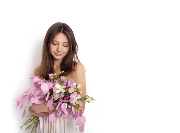 Happy surprised model woman smelling flowers — Stock Photo, Image