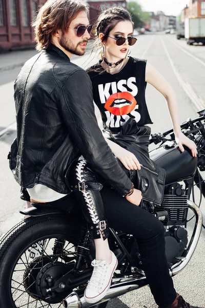 Young couple sitting on vintage motorcycle — Stock Photo, Image