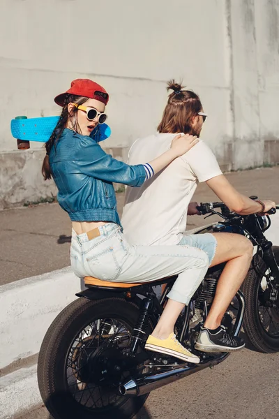 Young man and woman riding on sunny day — Stock Photo, Image