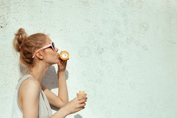 Happy girl blowing soap bubbles — Stock Photo, Image