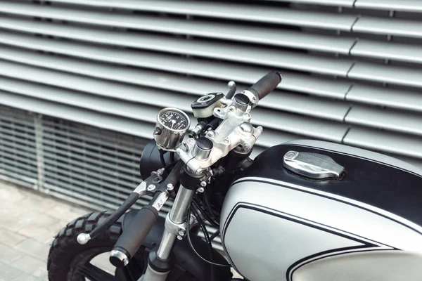 Motorcycle standing in dark building in rays of sunlight — Stock Photo, Image