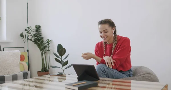 Chica sentada en casa y hablando por teléfono —  Fotos de Stock