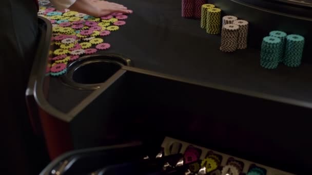 Croupier takes chips off table — Stock Video