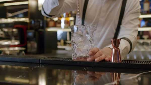 bartender mixing cocktail at bar