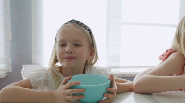 Two children eat healthy breakfast clipart