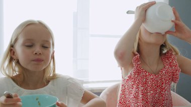 Two children eat healthy breakfast clipart