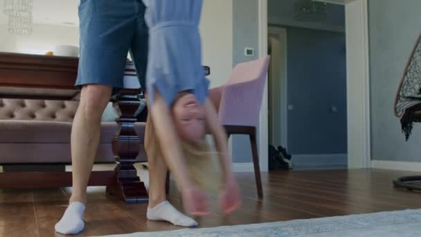 Father holding daughter upside down — Stock Video