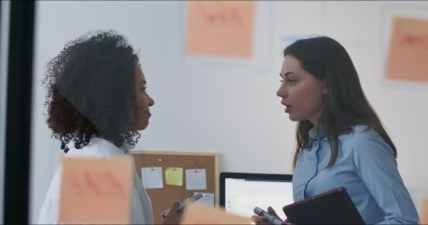 Жіночі офісні працівники використовують скляну дошку — стокове відео