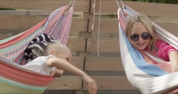 Two sisters having rest in hammock — Stock Video