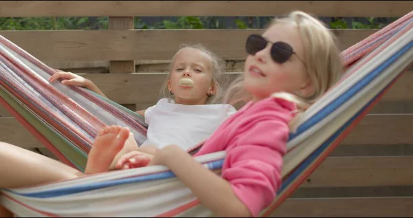 Two sisters having rest in hammock — Stock Photo, Image