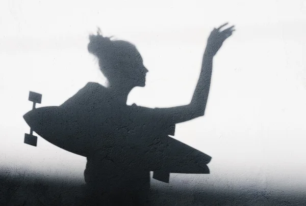 Photo of shadows of girl with a skateboard — Stock Photo, Image