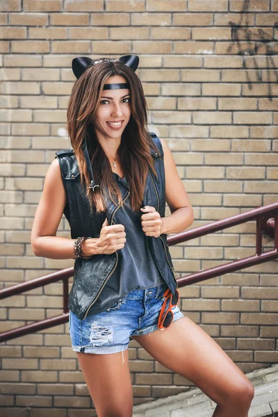 Bad sexy woman with leather cat ears showing tongue — Stock Photo, Image