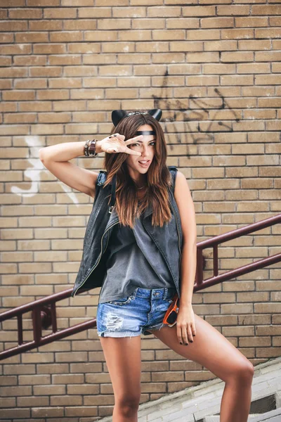 Bad sexy woman with leather cat ears  showing fingers ang tongue — Stock Photo, Image