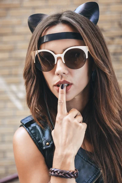 Bad sexy woman in sunglasses with leather cat ears — Stock Photo, Image