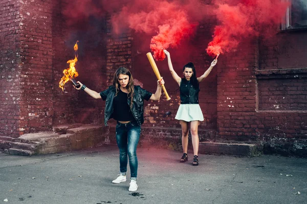 Two aggressive women with Molotov cocktail bomb in the street