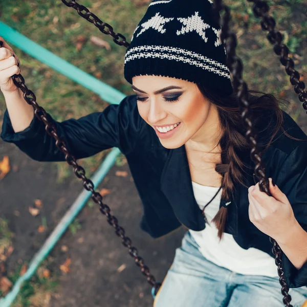 Portrait of a beautiful hipster girl on a swing — Stock Photo, Image