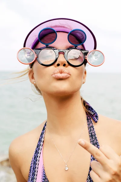 Mujer rubia joven en gafas de sol mostrando el dedo medio —  Fotos de Stock