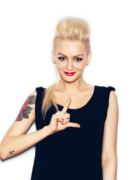 Blonde woman in a black dress holding her hair — Stock Photo, Image