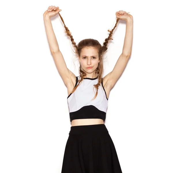 Fashion girl hipster with pigtails in a black skirt — Stock Photo, Image