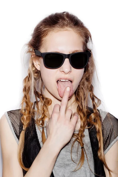 Cute woman wearing sunglasses and licking middle finger — ストック写真