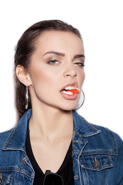 Young sexy woman biting gelatin candy — Stock Photo, Image