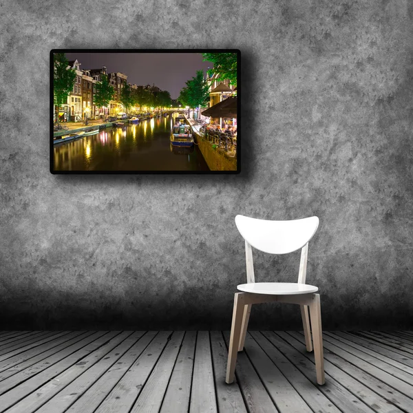 Plasma TV on the wall of the room with empty chair — Stock Photo, Image