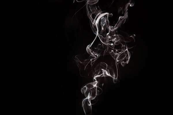 Abstract black and white smoke on the black background in studi