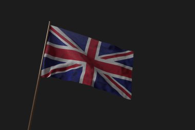 Büyük Britanya Birleşik Krallığı ve Kuzey İrlanda bayrağı bayrak direğiyle rüzgarda dalgalanıyor.