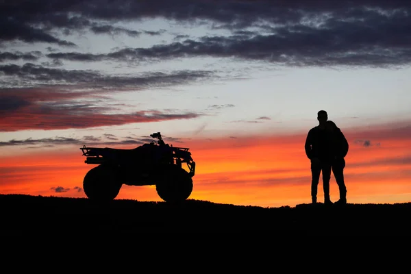 Silhouette ATV or Quad bike in the sunset. Holiday exploration concept with silhouette of quad bike