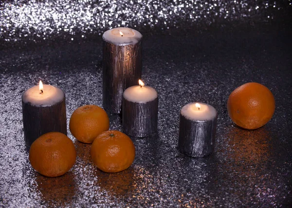 buring silver candles with oranges for christmas