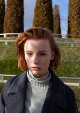 Parkta yürüyen güzel kızıl kız.