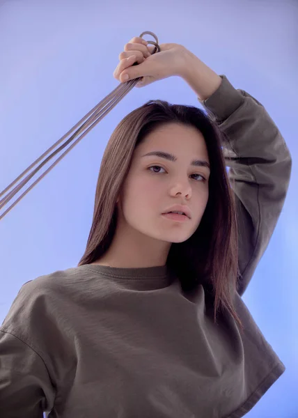 portrait of a woman with skipping rope on blue background