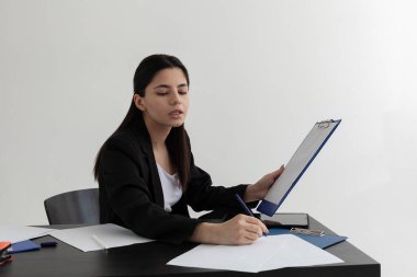 Güzel esmer, ofisteki masada çalışıyor.