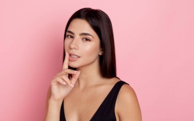 Pembe arka planda güzel makyajlı esmerin yakın portresi