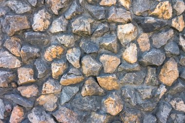 Duvarın bir parçası. Granit molozlu beton duvar dokusu.