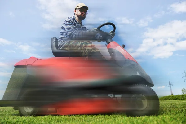 Ride-on lawn mower cutting grass. Stock Image