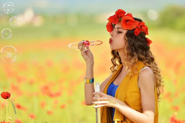 Brunette woman blowing soap bubbles