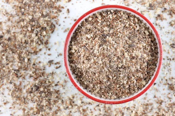 Blessed milk thistle seeds in a bowl on white background