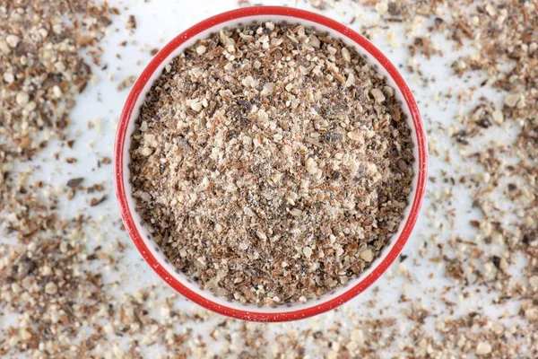 Blessed milk thistle seeds in a bowl on white background