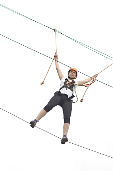 Happy girl climbing between trees — Stock Photo, Image