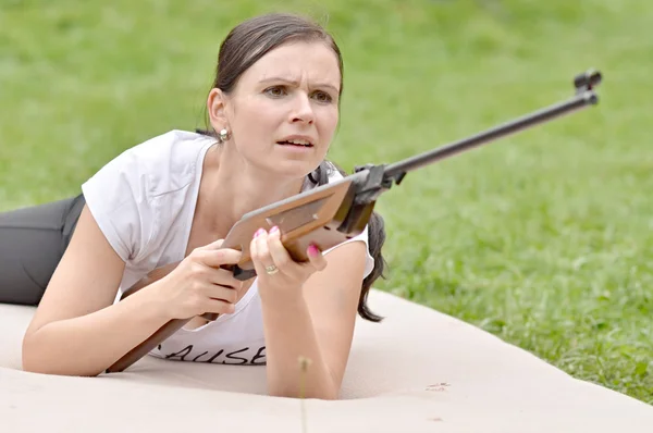 Girl aiming a pneumatic rifle — Stock Photo, Image