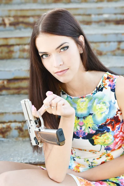 Beautiful woman with gun — Stok fotoğraf