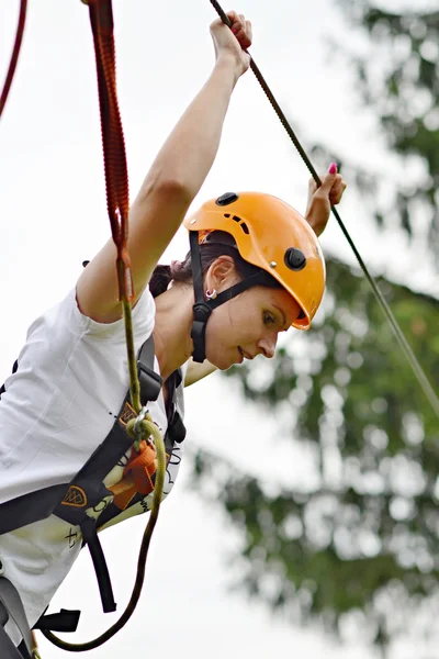 Happy girl climbing between trees — Stock Photo, Image