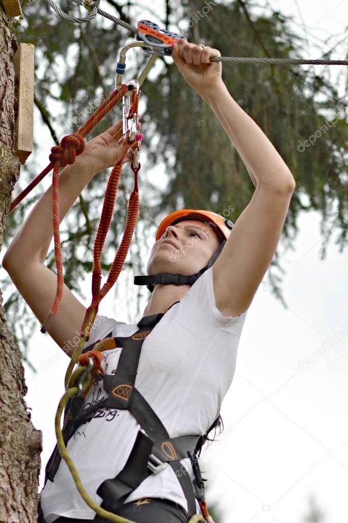 Happy girl climbing between trees